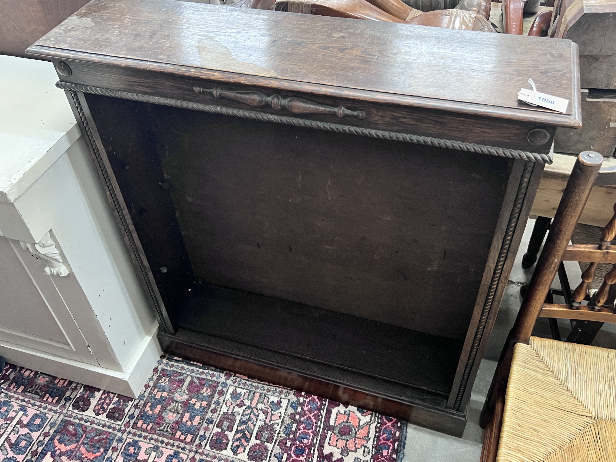 An early 20th century oak open bookcase, length 99cm, depth 25cm, height 107cm